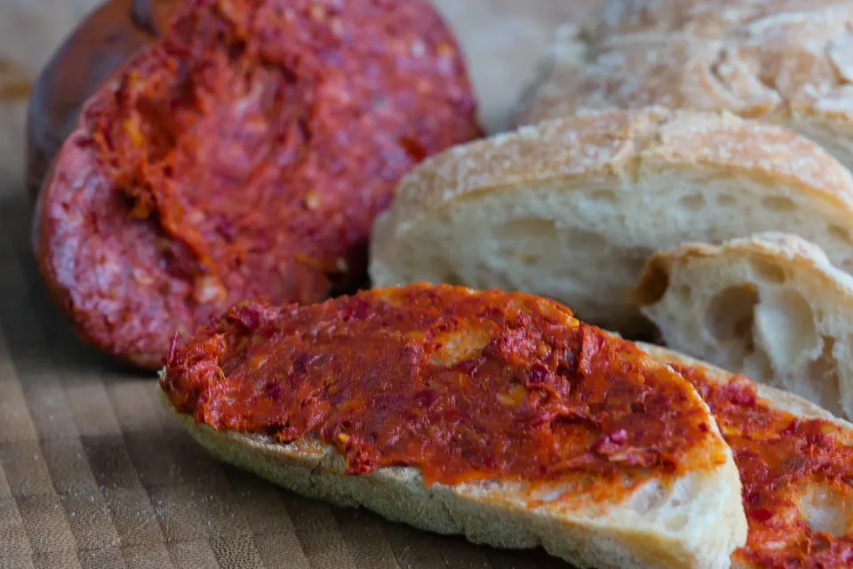 'Nduja sliced and spread on bread, illustrative photograph