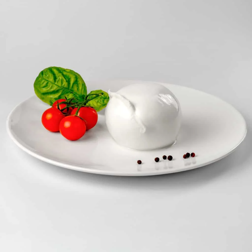 Jemma mozzarella on a plate with cherry tomatoes and basil
